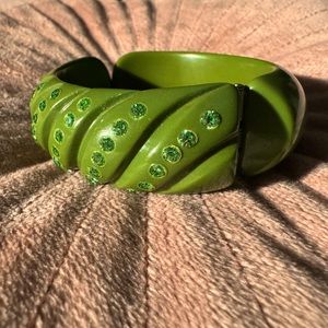 Vintage Bakelite hinged cuff bracelet. Avocado rhinestones plus deep cuts.